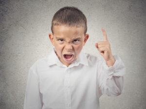 Closeup Portrait Angry child, Boy Screaming finger pointing up, demanding justice isolated grey wall background. Negative human Emotions, Facial Expressions, body language, attitude, perception